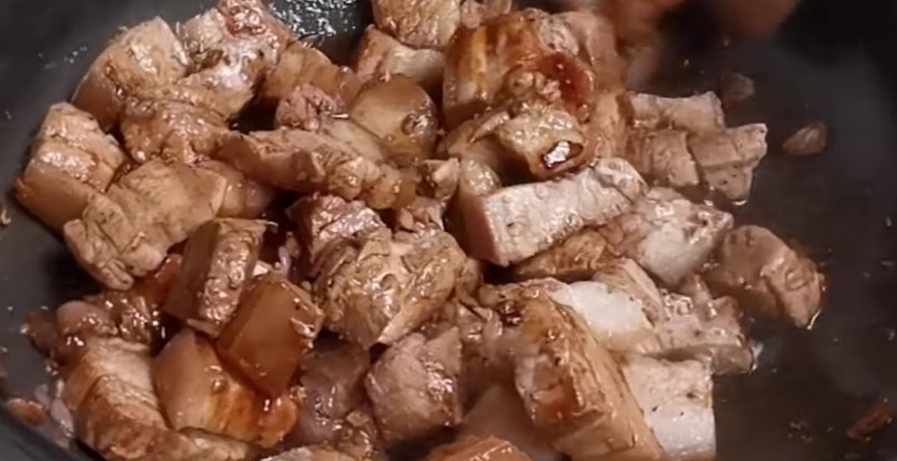 Add soy sauce + spices. Pour in the soy sauce, peppercorn, and bay leaves. Cook for a few minutes so the pork absorbs flavor.
