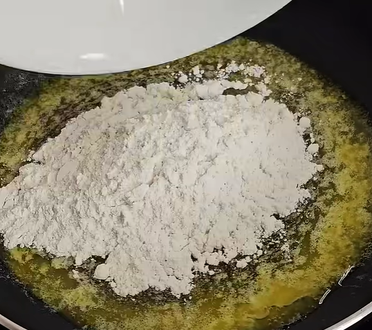 Add the flour and whisk continuously for about 1-2 minutes until it turns light golden brown.