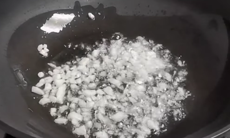 Sauté aromatics. Heat oil in a pot. Add garlic and sauté until lightly browned. Add onions and cook until soft and fragrant.
